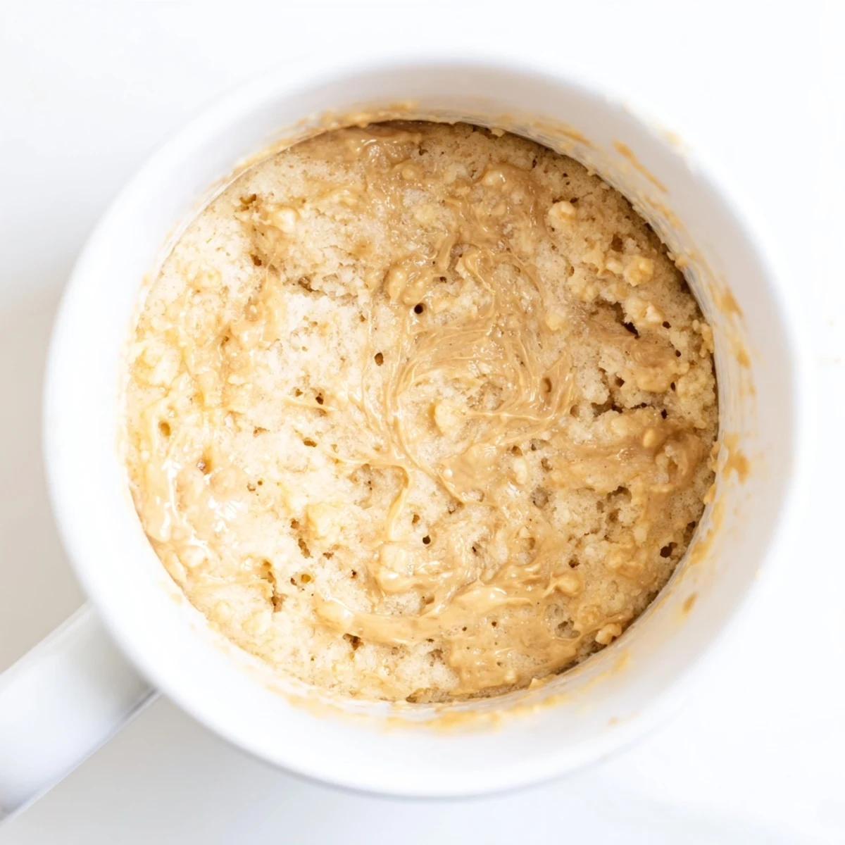 Golden, steaming 2-Minute Peanut Butter Mug Cake, ready to be enjoyed straight from the mug for one.