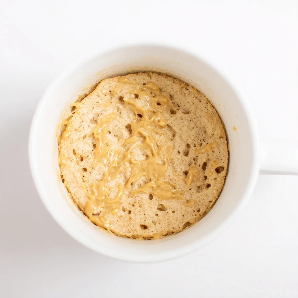 A warm 2-Minute Peanut Butter Mug Cake, a perfect quick dessert with a light, fluffy texture.