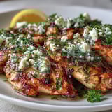 Juicy slices of Greek Chicken with Lemon and Feta served over fluffy rice with a crisp side salad.