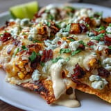 Bright corn, melted cheese, and smoky chipotle crema atop Cinco de Mayo Elote Nachos.