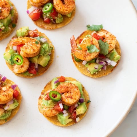 Golden-crisped tostadas topped with vibrant shrimp and creamy avocado, ready for a delicious, quick meal.