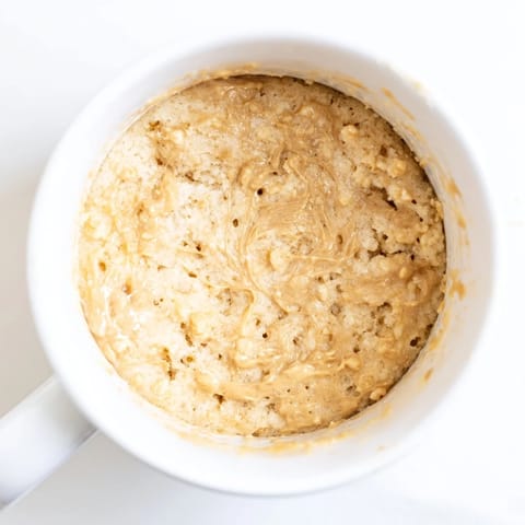 Golden, steaming 2-Minute Peanut Butter Mug Cake, ready to be enjoyed straight from the mug for one.