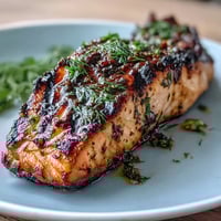 Grilled Lemon Herb Salmon with Asparagus and Cherry Tomatoes, a healthy Mediterranean dish bursting with fresh flavor. Juicy salmon fillets marinated in lemon and herbs, served alongside tender grilled asparagus and blistered cherry tomatoes. A quick, gluten-free dinner perfect for busy weeknights.