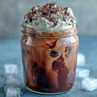 Chocolate cream cold brew with rich coffee and velvety chocolate topping served over ice.